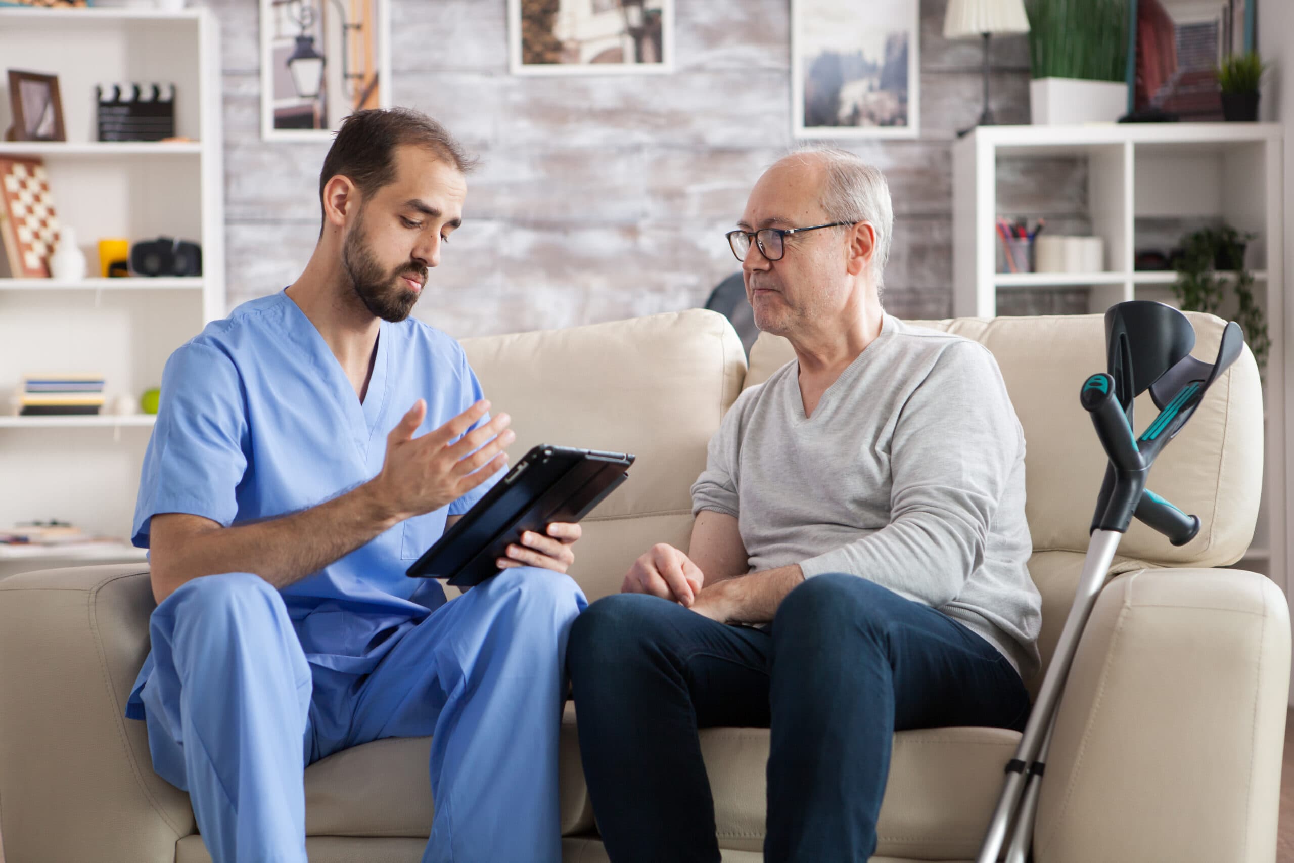 Young doctor in nursing home checking elderly age man treatment Young doctor in nursing home checking elderly age man treatment